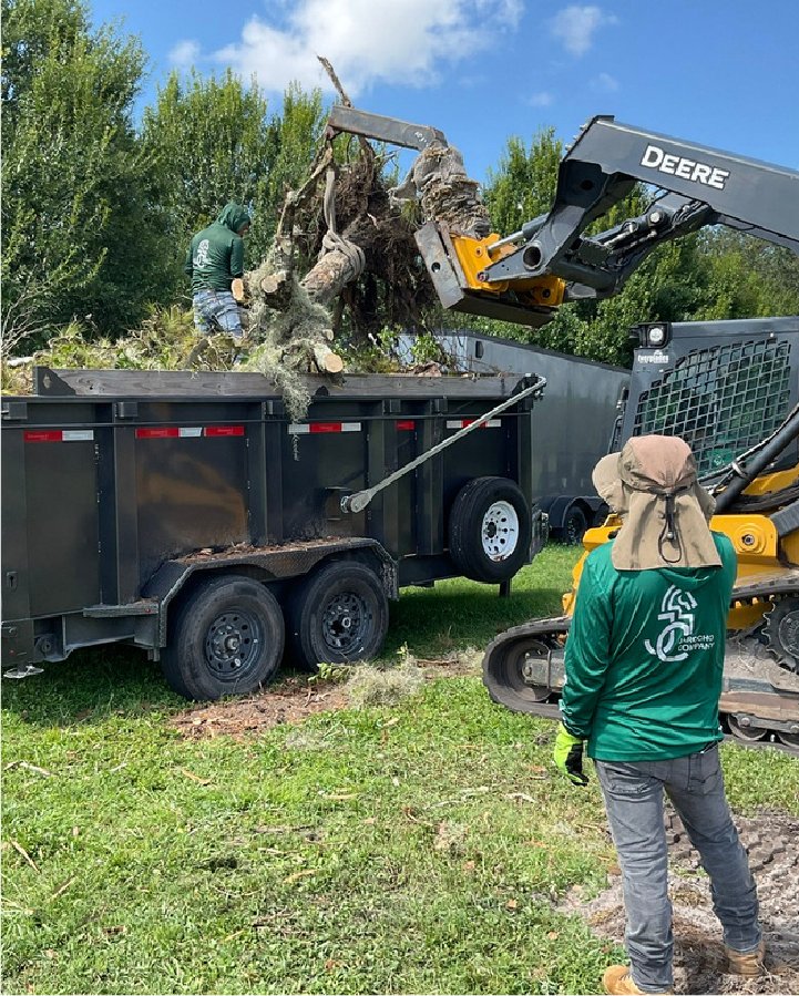 Crew loading storm debris into a trailer in Wellington
