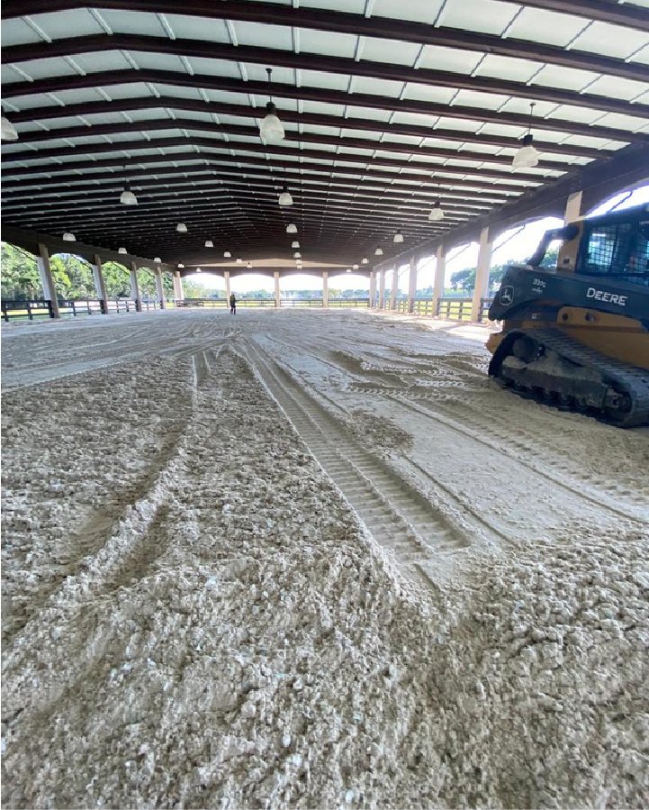 Covered arena footing being groomed